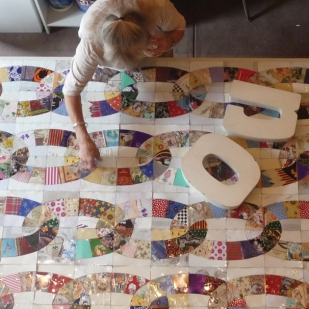 Janet De Berge Lange at work in her studio on “No,” a traditional quilt pattern made from untraditional materials